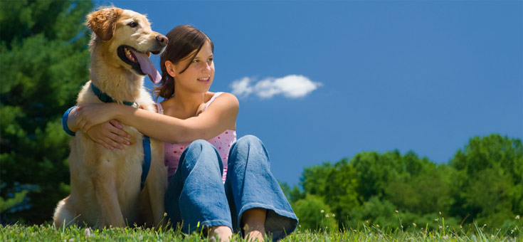 photo of girl & dog in field